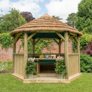 Forest Garden 3.6m Hexagonal Wooden Garden Gazebo with Thatched Roof - Furnished with Table, Benches and Cushions (Green)