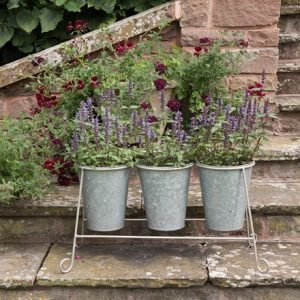 Three galvanised metal pots and stand